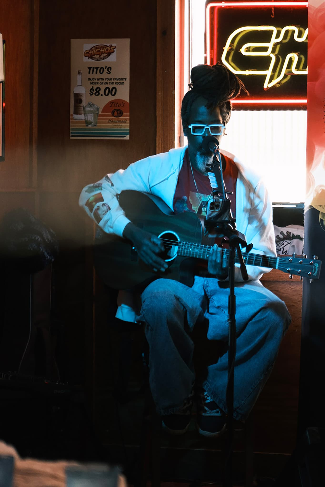 Musician performing with neon sign